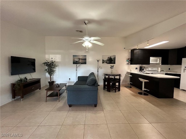 living room with ceiling fan, light tile patterned floors, and track lighting