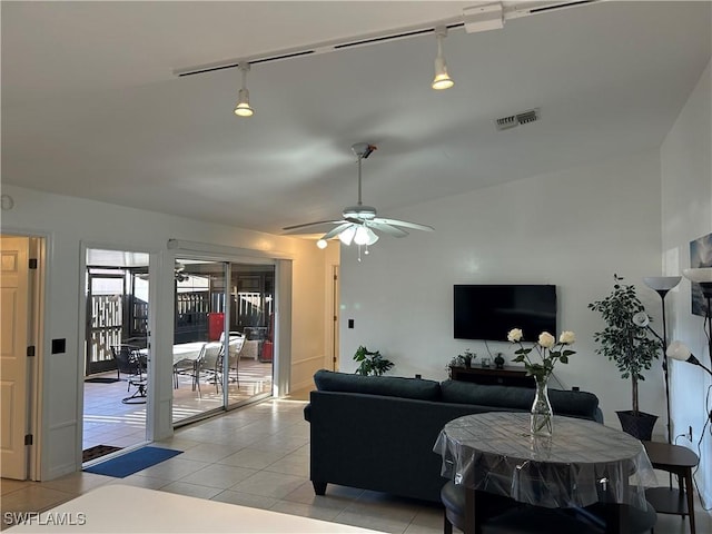 tiled living room featuring ceiling fan and track lighting