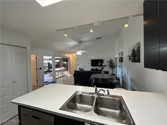 kitchen with ceiling fan, light tile patterned flooring, track lighting, dishwasher, and sink