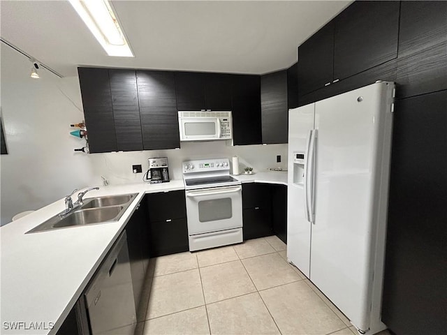 kitchen featuring light tile patterned floors, sink, and white appliances