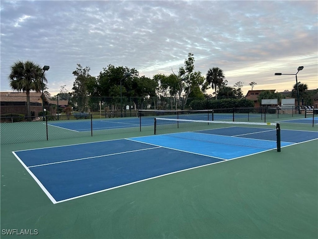 view of tennis court with basketball hoop