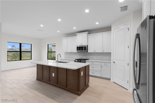 13617 Heritage Preserve Dr, Fort Myers, FL 33905 - kitchen with appliances with stainless steel finishes, a sink, light countertops, decorative backsplash, and recessed lighting