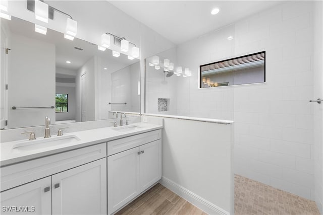 13617 Heritage Preserve Dr, Fort Myers, FL 33905 - bathroom featuring double vanity, a walk in shower, wood finished floors, and recessed lighting