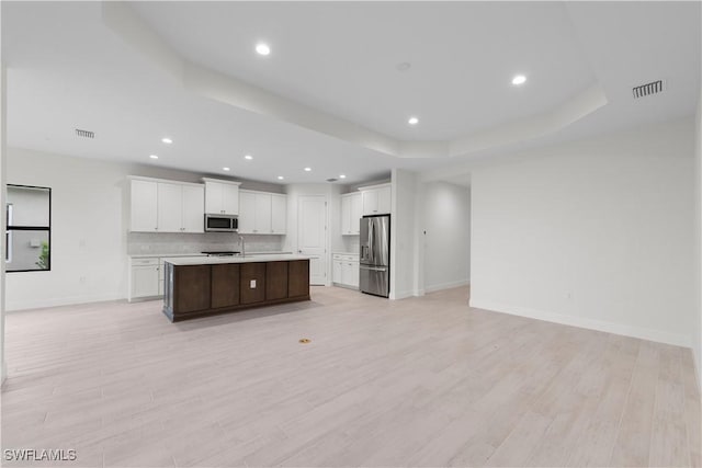 13617 Heritage Preserve Dr, Fort Myers, FL 33905 - kitchen featuring appliances with stainless steel finishes, open floor plan, light countertops, white cabinets, and baseboards
