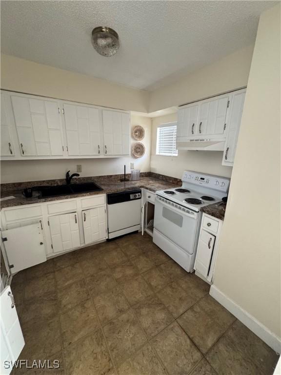 kitchen featuring a textured ceiling, sink, white cabinets, and white appliances