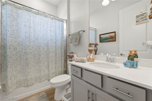 full bathroom featuring hardwood / wood-style flooring, vanity, toilet, and shower / bathtub combination with curtain