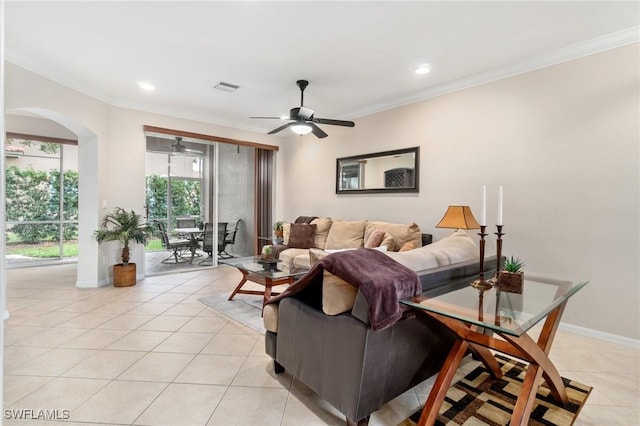 tiled living room with crown molding and ceiling fan