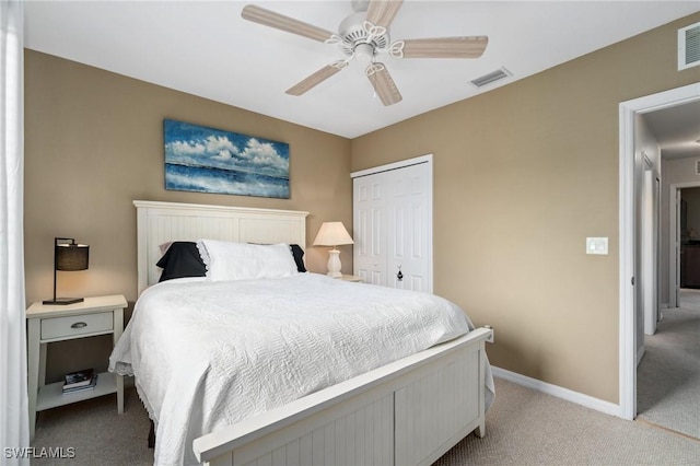 bedroom featuring ceiling fan, light carpet, and a closet