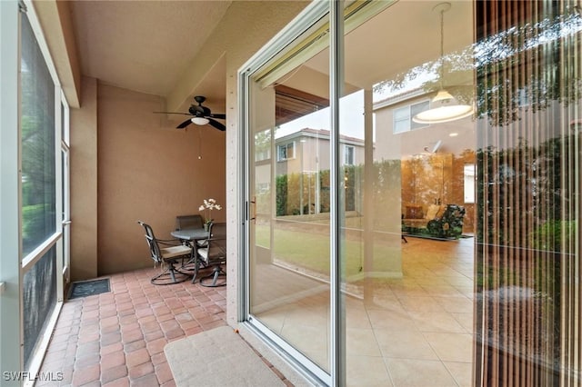 sunroom featuring ceiling fan