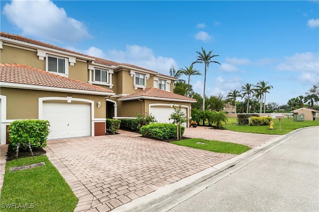 view of front of property with a front yard and a garage