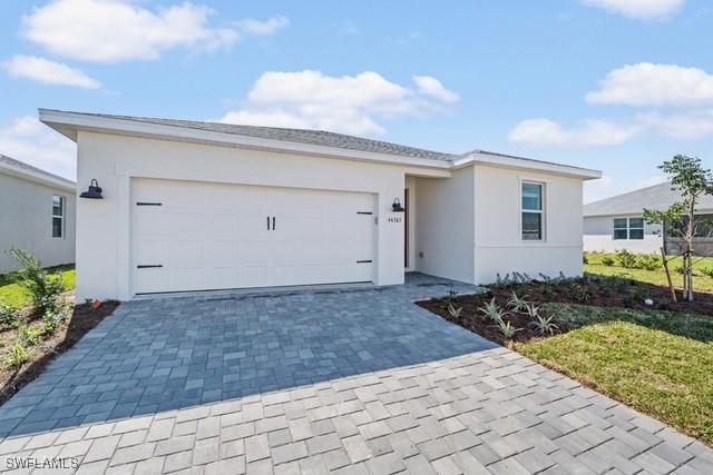 ranch-style home with a garage and a front yard