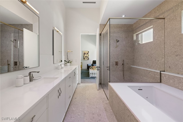 full bath with a sink, tiled shower, a garden tub, and double vanity