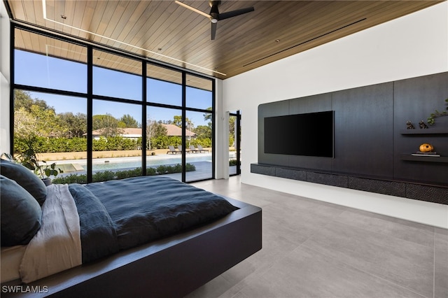 bedroom with access to exterior, floor to ceiling windows, wood ceiling, and a towering ceiling