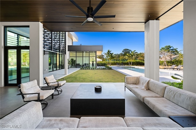 view of patio / terrace with an outdoor pool, outdoor lounge area, and a ceiling fan