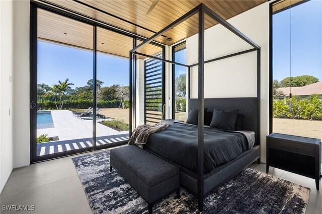 bedroom with wood ceiling, finished concrete floors, and access to exterior