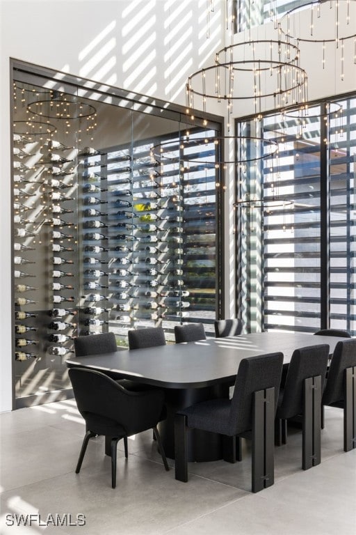 dining area with a notable chandelier and a towering ceiling