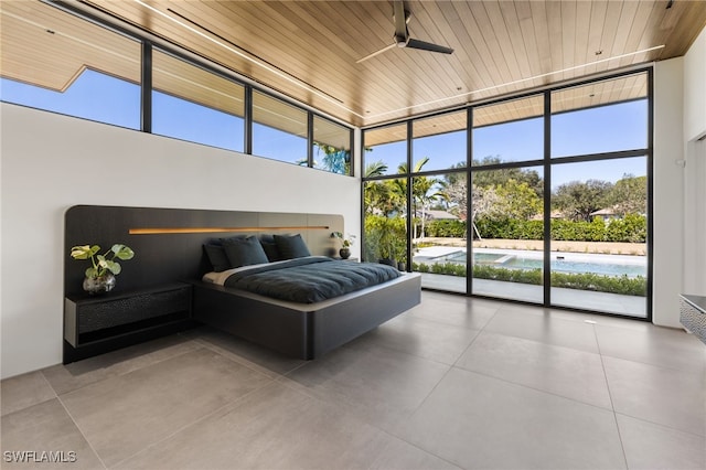 bedroom with a wall of windows, multiple windows, wood ceiling, and access to outside