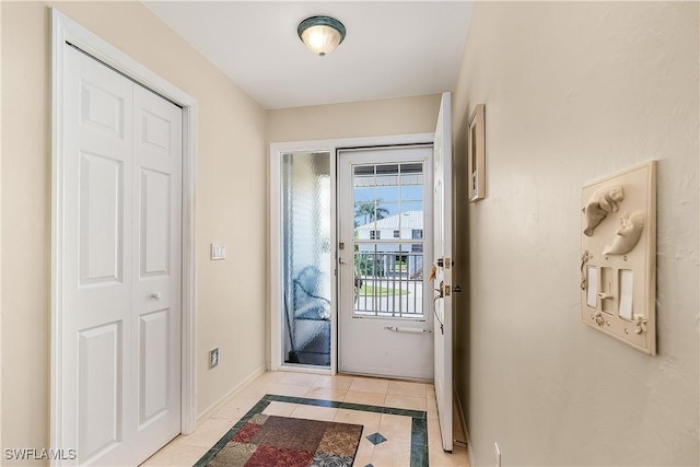 entryway with light tile patterned flooring