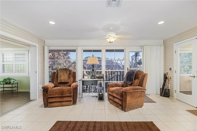 living area featuring ceiling fan and light tile patterned flooring