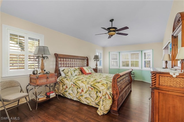 bedroom featuring ceiling fan, dark hardwood / wood-style flooring, and multiple windows