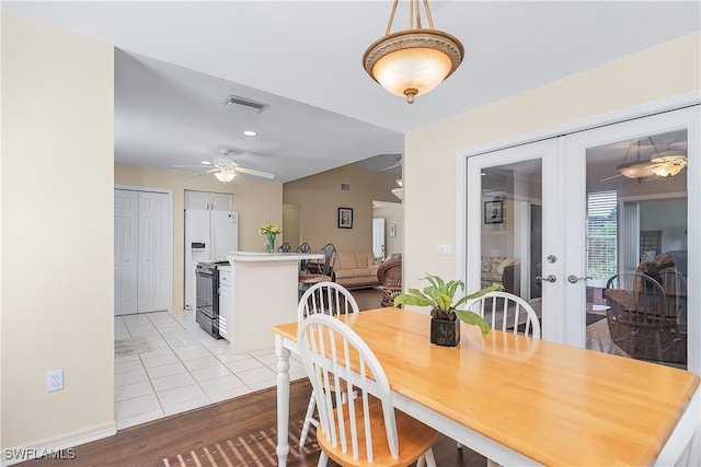 dining area featuring ceiling fan, french doors, and light hardwood / wood-style flooring