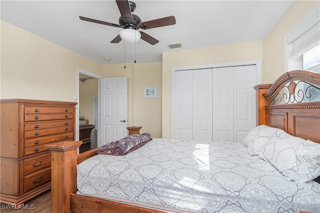 bedroom featuring hardwood / wood-style flooring, ceiling fan, and a closet