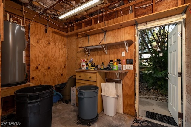 basement with water heater and wood walls