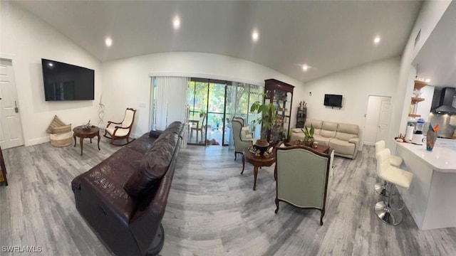 living area with lofted ceiling, recessed lighting, baseboards, and wood finished floors