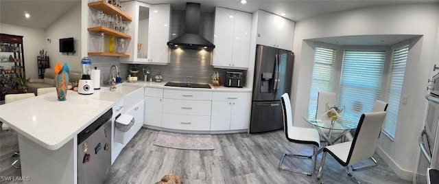 kitchen featuring black electric cooktop, a peninsula, open shelves, refrigerator with ice dispenser, and wall chimney exhaust hood