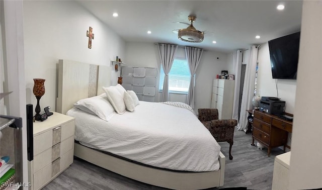 bedroom with wood finished floors and recessed lighting