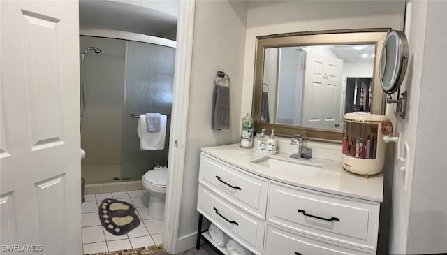 bathroom featuring toilet, a shower stall, vanity, and tile patterned floors