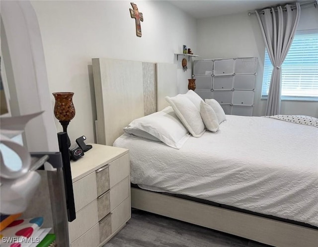 bedroom with dark wood-style flooring