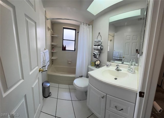 full bath featuring a skylight, toilet, tile patterned floors, shower / bath combo with shower curtain, and vanity