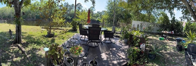 deck with a patio area and a lawn