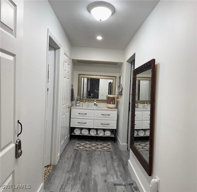 full bathroom with vanity, baseboards, and wood finished floors