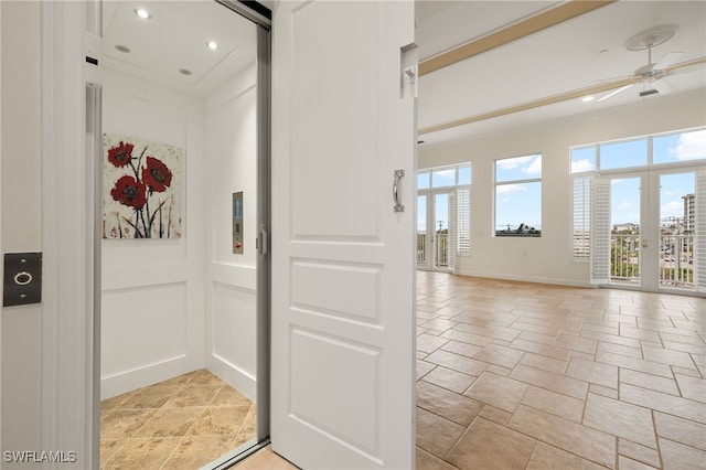 interior space featuring ornamental molding, elevator, and ceiling fan