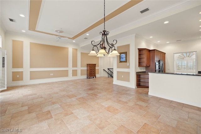 kitchen with decorative light fixtures, stainless steel refrigerator, ornamental molding, a raised ceiling, and ceiling fan with notable chandelier