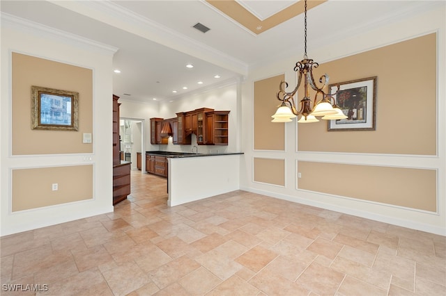 kitchen with pendant lighting, ornamental molding, a chandelier, and kitchen peninsula