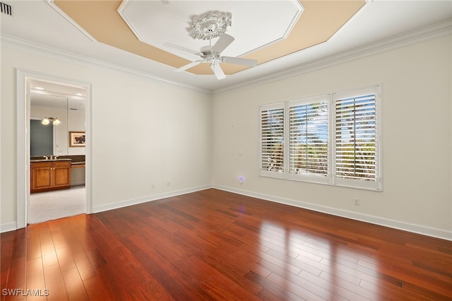 unfurnished room featuring crown molding, wood-type flooring, and ceiling fan