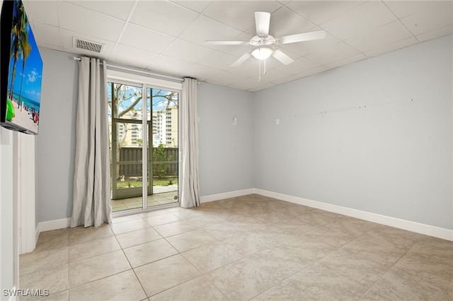 tiled empty room featuring ceiling fan