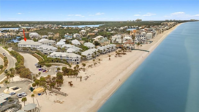 drone / aerial view featuring a view of the beach and a water view