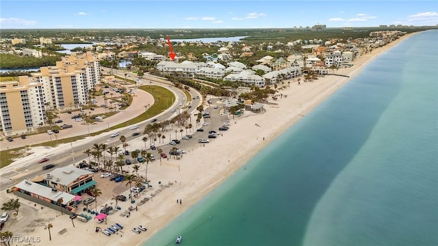 drone / aerial view featuring a water view and a view of the beach