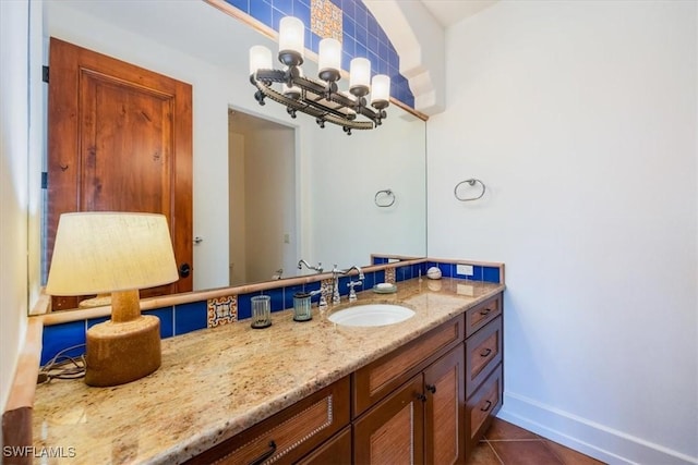 bathroom with backsplash, tile patterned flooring, and vanity