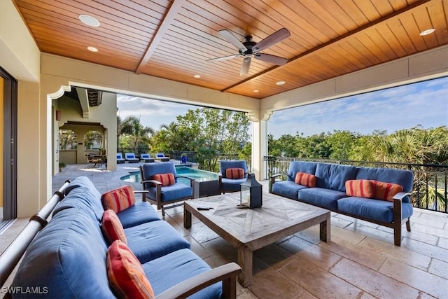 view of patio / terrace with a fenced in pool, outdoor lounge area, and ceiling fan