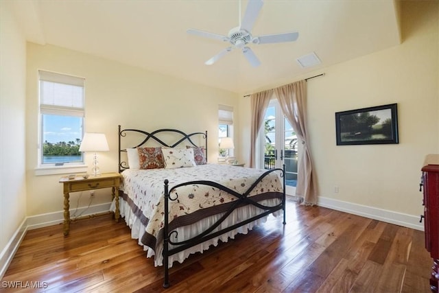 bedroom with access to outside, hardwood / wood-style flooring, and baseboards