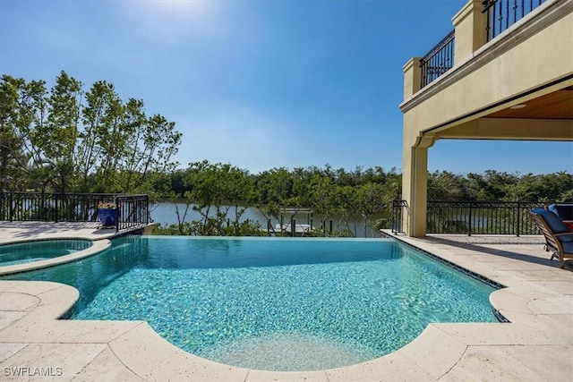 view of swimming pool featuring a patio area and a pool with connected hot tub