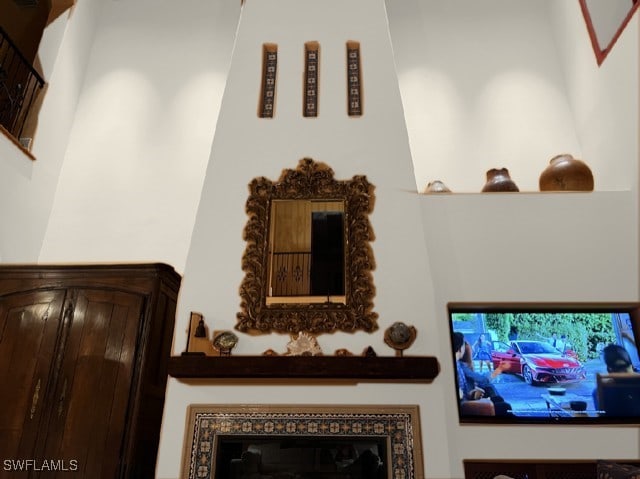 interior details with a glass covered fireplace