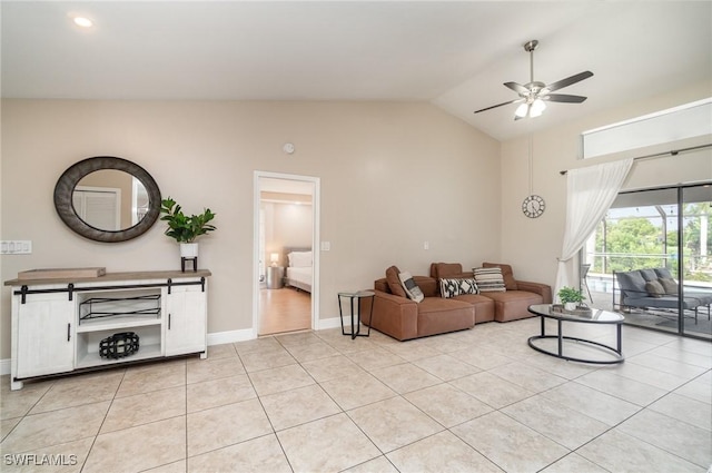 living room with ceiling fan, light tile patterned floors, and vaulted ceiling