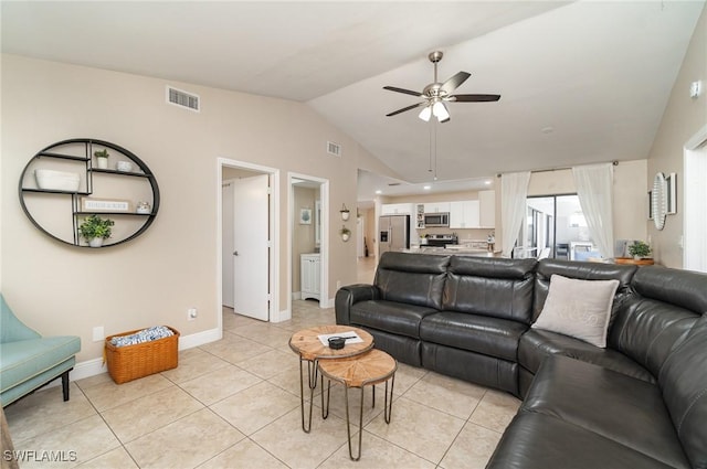 living room with ceiling fan, light tile patterned flooring, and vaulted ceiling