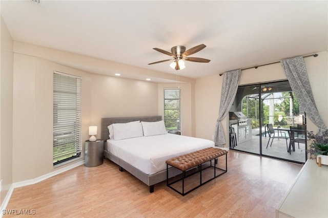 bedroom featuring ceiling fan, light wood-type flooring, and access to outside